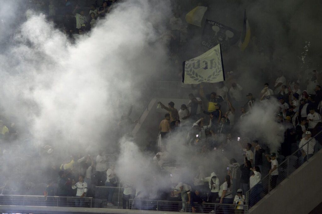 LA Galaxy fans and flags are obscured by plumes of white smoke rising from the away end at BMO Stadium. - Photo by Luke Netzley