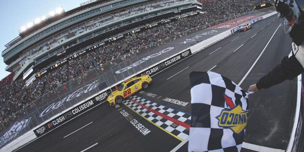 Joey Logano, driver of the No. 22 Shell Pennzoil Ford, takes the checkered flag to win the NASCAR Cup Series Busch Light Clash at the Los Angeles Memorial Coliseum on Feb. 6, 2022, in Los Angeles. - Photo by Sean Gardner